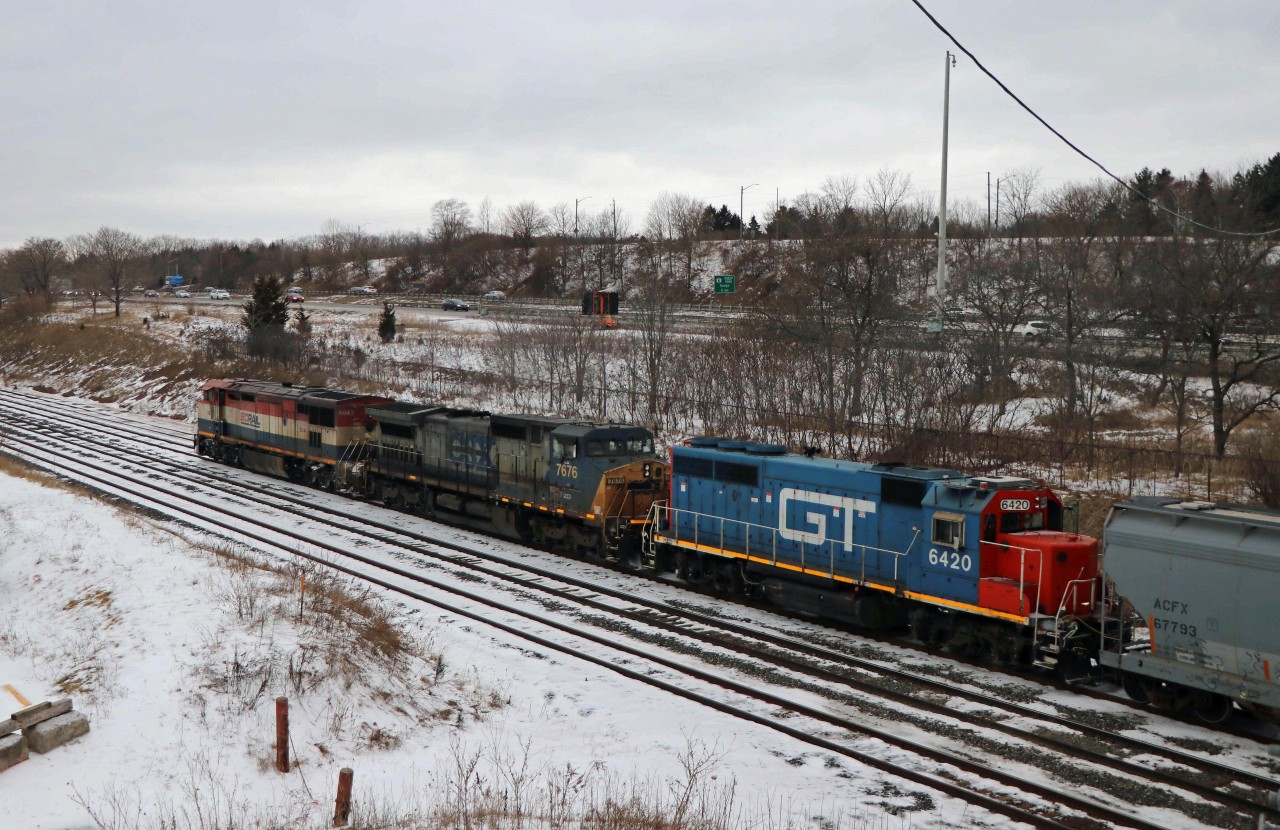 While waiting for CN 148 with reported FPON, I was pleasantly surprised by 383 with the interesting consist of BCOL C40-8m 4623, GECX 7676 (ex CSX C40-8W) and GTW GP40-2 6420, one of the last units still in "Burdakin blue". (They met 148 with a UP leader around Dundas.)