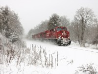 After a few days of snow and freezing rain, another burst of snow arrives as CP 246, with CP 8911 and CP 8816, head south down the Hamilton sub as they pass mile 74.