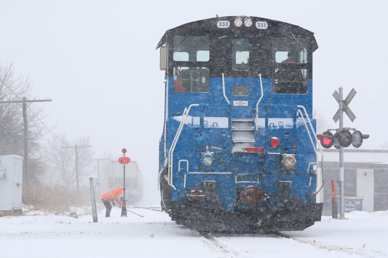 When you work for the railway you have to be prepared to deal with any weather conditions. Today for the OBRY crew it was a blinding blizzard mixed with freezing rain. Even with the terrible weather I still got a friendly hello before the brakeman set off to fight a frozen switch. Today the train headed light power from Orangeville to lift a healthy northbound cut of cars. Reportedly the train stalled north of Brampton. It is surprising what this crew can do with a lone end cab switcher considering the terrain.
