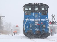 When you work for the railway you have to be prepared to deal with any weather conditions. Today for the OBRY crew it was a blinding blizzard mixed with freezing rain. Even with the terrible weather I still got a friendly hello before the brakeman set off to fight a frozen switch. Today the train headed light power from Orangeville to lift a healthy northbound cut of cars. Reportedly the train stalled north of Brampton. It is surprising what this crew can do with a lone end cab switcher considering the terrain. 