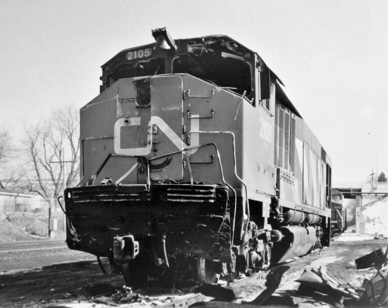 The aftermath. The remains of CN HR616 2105 are seen two days after being in the lead of train 272 when it was involved in a major rear-end collision on the Strathroy Subdivision. The unit was on the point of the eastbound train, when it rear-ended standing manifest 308 at Hyde Park. In turn, the force of the impact pushed train 308 into the rear of train 223, another standing freight which was stopped ahead of it. The collision was enough to derail both 2105 and second unit, LMSX C40-8W 723. The locomotives suffered heavy damage, with 2105 bearing the worst of it. Fortunately, the crews involved escaped with non-life threatening injuries. The LMSX lessor would be repaired, however 2105 was subsequently retired on October 26, 1995 after it was determined the damage was too extensive and it would be too costly to repair the aging locomotive. The Transportation Safety Board later determined that the locomotive engineer of train 272 missed a restrictive signal indication west of Hyde Park, but was unable to slow the train down as it approached and struck the stopped 308. This is a follow-up to the series of photos that John Pittman recently posted on the incident.