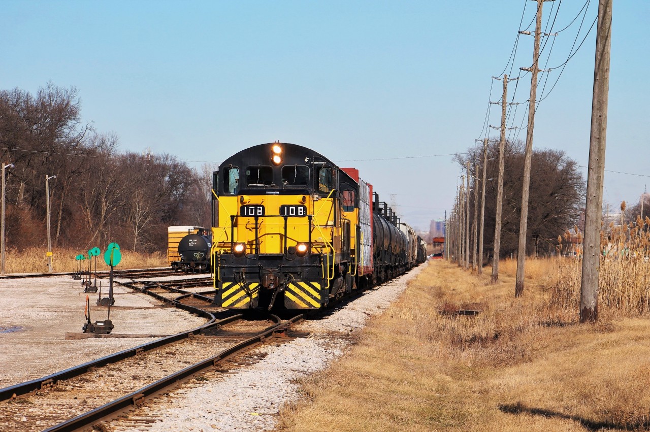 The morning ETR job pauses for a moment while the conductor prepares the train for kicking operations in Ojibway Yard. This yard is used to service several of ETR's biggest customers on their network along with storage for LPG tank cars.
