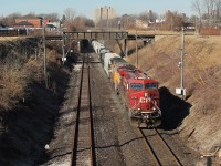  CP 240 emerges from the Detroit River rail tunnel on a sunny Saturday afternoon. About 3 minutes earlier, an ETR local passed over the bridge in the background. One day I will get an over/under meet here between CP and ETR. The tunnel between Windsor and Detroit was built in 1910 by the Michigan Central Railroad and has gone through some major transformations, and different owners over the years. Today CP owns the tunnel and is the only railroad that uses it regularly, compared to a few decades ago when multiple railroads ran trains through it. The tunnel was enlarged in 1994 to accommodate excess height traffic, but still cannot handle large cubed double stack intermodal.
