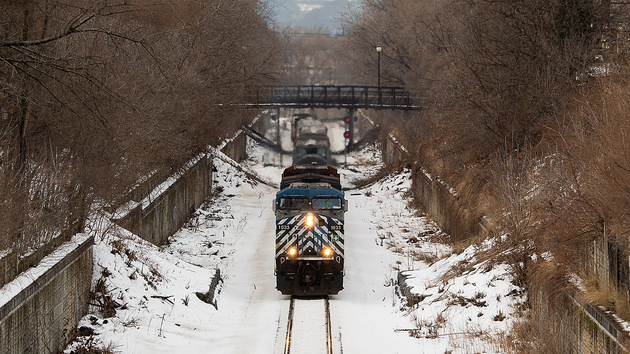 I wasn't intending on taking this shot - I was in the area solely to shoot northbound pushers who had just passed through on their way to push a waiting (and very late) 142. After I shot the pushers and got back to my car, I heard CEFX 1033 south at Desjardins and scurried over to Queen Street as I had been thinking about maybe trying a time machine photo with Arnold Mooney's shot of a southbound just west of tunnel on the Hamilton Sub. Unfortunately, the trees on Queen Street are so grown in with branches everywhere that it's currently impossible to reproduce the angle and show that much sky. It took a little telephoto to get past the branches for this one.