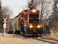 Things seemed pretty busy for Trillium when I was down in the area earlier this month. After shooting <a href="http://www.railpictures.ca/?attachment_id=36412">564 rescuing 538/meeting 143 at Robbins</a>, I found Trillium working Feeder Yard around 0900, building a train of grain hoppers for Port Colborne. They departed not long after, working WH Yard briefly along the way. This yard too had quite a few grain hoppers kicking around in it. Making the slow and steady trek south to the Port, they made a setoff of grain hoppers at the old Robin Hood mill that originated off of CP. There, they lifted CN-originated hoppers off of a siding for the Port Colborne Grain Terminal and/or ADM (I am not sure which they were for, or perhaps both). It was a really windy day, and unfortunately the wind was doing its best from preventing me getting a really smoky ALCO shot. Later that day I would see CP drop another big string of grain hoppers for Trillium at Feeder Yard, shown <a href="http://www.railpictures.ca/?attachment_id=36426">here</a>.