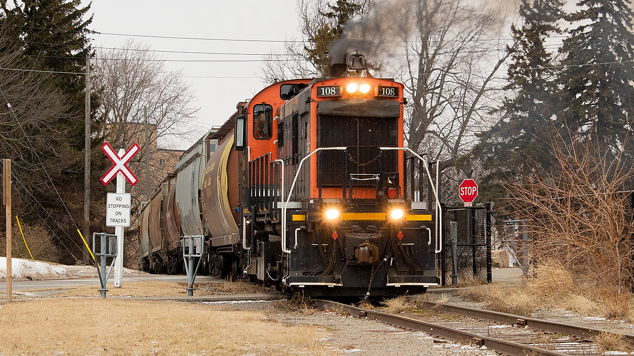 Things seemed pretty busy for Trillium when I was down in the area earlier this month. After shooting 564 rescuing 538/meeting 143 at Robbins, I found Trillium working Feeder Yard around 0900, building a train of grain hoppers for Port Colborne. They departed not long after, working WH Yard briefly along the way. This yard too had quite a few grain hoppers kicking around in it. Making the slow and steady trek south to the Port, they made a setoff of grain hoppers at the old Robin Hood mill that originated off of CP. There, they lifted CN-originated hoppers off of a siding for the Port Colborne Grain Terminal and/or ADM (I am not sure which they were for, or perhaps both). It was a really windy day, and unfortunately the wind was doing its best from preventing me getting a really smoky ALCO shot. Later that day I would see CP drop another big string of grain hoppers for Trillium at Feeder Yard, shown here.