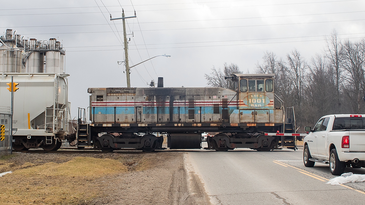 LTEX 1001, the switcher at Oxy Vinyls in Port Robinson, is pictured here shoving a cut of plastic pellet hoppers across Thorold Townline Rd into the plant property. There is what I am assuming to be an interchange point between the plant and CN on the west side of the road and the switcher shuttles hoppers back and forth. I saw it make a few trips between the plant and the interchange on this day, in what was a rather busy day for me railfanning-wise. There are a couple of trackmobiles within the plant property itself as well.