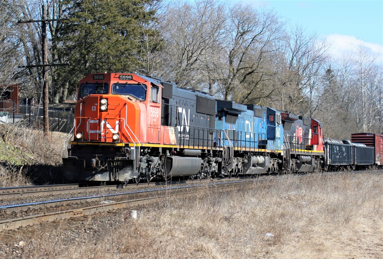 CN train 435 with 5696, IC 2462 and 2124 curve through Paris, Ontario with work at Paris West ahead.