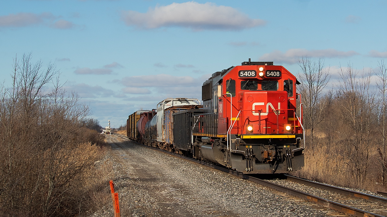 CN L562 had just departed Port Rob, and is seen here shortly after some brief work at Southern Yard. They are headed for the Hamilton Sub to access Feeder Yard to interchange with Trillium. I don't know too much about Trillium's operations and customers - can anyone please tell me who gets gons from them? I often see the second gon on this train (or ones just like it) on 421/422 and have always wondered where they go. It had an SLMX reporting mark.