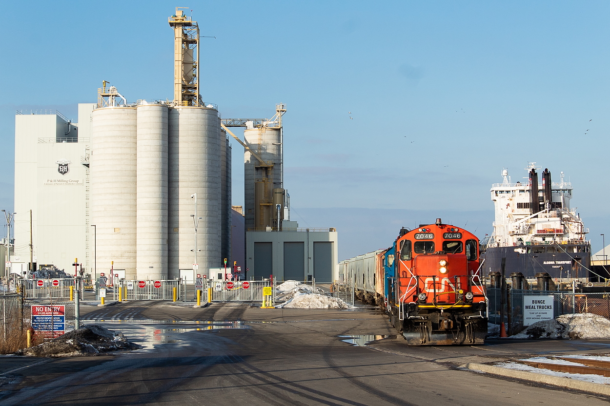 I was able to somewhat finish work early yesterday and caught the 0700 job at Stelco around midday, which was a feat in and of itself to me. I had a couple conference calls yet to make though, so I went home to handle those. When I was out earlier, it looked like to me from what I could see in both Stuart and P&H itself that P&H would be getting serviced later on so I thought I would go back out after the calls just in case. Shortly after 3pm I went back out and first came across 1400 yard job busy working Stuart with 4781 and 4713. 4781 is the beltpack-equipped unit and was evidently having some recurring wheel slip issues ("4-7-8-1-A severe wheel slip, out"). Not long after getting to Stuart the 1500 crew got in their power, which was the same power as the 0700 crew. It still had the 0700's drag behind it (including a completely unpainted three-pack of well cars out of NSC) so they took that down to the far west end of the yard and returned light. They and tacked onto the western side of four hoppers (three of which were P&H-owned) and then called for a light down the hole. They shoved from Stuart all the way to P&H, where I had now been waiting for a bit of time. They tied onto the three hoppers already at P&H and shoved those further in, along with the four they brought on this day. The next move was to head over to Bunge to lift meal hoppers, but by this point I had to go. The ship pictured right - the Algoma Transport - is at Bunge for the winter. It has a load of canola for them all winter, and it gets a place to dock for the off-season. If anyone is wondering, I think P&H is typically a late afternoon move. Mark MacCauley previously shot SOR here on their last day of operations in Hamilton.