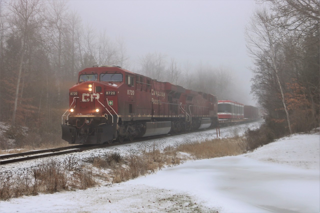 Out of the fog and freezing drizzle comes CP 246 headed south with CP 8720 and CP 9537 for power hauling a special car with TTC streetcar 4478 along for the ride where it will be dropped of in Welland.