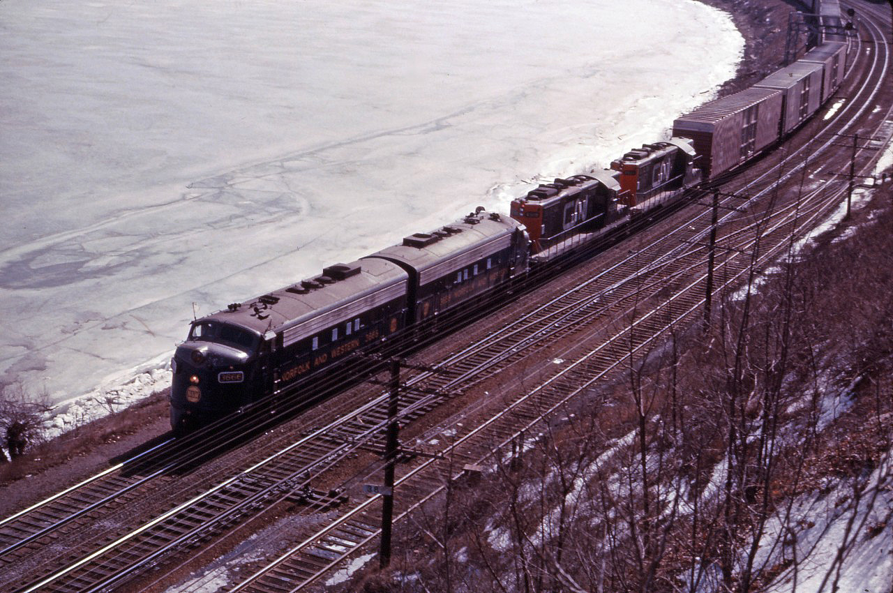 1967 was a good year for train watching in southern Ontario. Not only was it Centennial year with its extra passenger traffic, we had a new commuter service into Toronto (the now well-established GO Transit), new locomotives (C424s, GP40s and SD40s on CN; SD40s and C424s delivered in 1966 on CP); the "last hurrah" for older MLW and CLC locomotives on CN before retirement; the last full year of NYC operations in Canada; the final year before adoption of the CP Rail paint scheme; 6218 excursions; and leased locomotives! For much of 1967, CN leased several N&W F7As and used them between Toronto, Fort Erie, Windsor, and Sarnia, sometimes in N&W only consists and sometimes mixed in with CN power. (There is even one known case of an N&W F7A-Ontario Northland FP7 combination!)

Here we see an eastbound train working Hamilton with a pair of N&W F7As and a pair of CN GP9s. "Those were the days, my friend!"