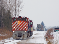 <b>Weekend Warriors</b>. Driving around the north end of Guelph, I wanted to try and catch the CN in town, as they have been pretty consistently coming to Guelph the last few weekends. On route, I start hearing scanner chatter, a positive sign, but I can never actually understand what they're saying on the radio unless I have my brother to translate the muffled conversations. Drive around for 15 minutes, no sign of CN. Then I hear "clear back towards the Hanlon, 647". Huh.... No wonder I couldn't find them. That led me to do a drive-by of Imperial rd where I thought they'd be, switching PDI at the west end of the South Spur. Hit the South Spur grade crossing: nothing. Bemused, annoyed and discouraged thought I'd cut my losses and call it a day. Continuing onto Woodlawn Rd to expedite the ending of my pointless outing I pass the North Spur when holy crap there they are. I had thought that the North spur was essentially "off limits" to OSR, as I know most of the industries (MBI, Sanimax and Gerdau) are served by CN, never occurred to me they'd be up there. I did notice that the crossing I was standing at had a "Guelph Junction Railway" sticker on it, which leads me to believe the North and South spurs aren't segregated by railway like I thought. And here, they appear to be handling storage cars parked at the end of the line, which could be for one of the industries on the South Spur (not the pole cars though, those are spotted along Edinburgh Road along the CN). This was also the first time I've known OSR to come up to Guelph on a weekend, which I assume happens on rare occasions. I don't think CN ever did make it to Guelph, but who cares, really when you have this. Any info or comments about CN/OSR spiting the spurs and how all that works or about OSR doing weekend runs North are welcome and encouraged. 