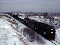 Toronto-Buffalo (Frontier Yard) train TF-2 struggles up the grade into Vinemount behind Penn Central F7As 1747, 1729 and GP9B 3829. Normally an overnight train, this morning it is quite late--likely due to a combination of winter weather and less-than-reliable power.