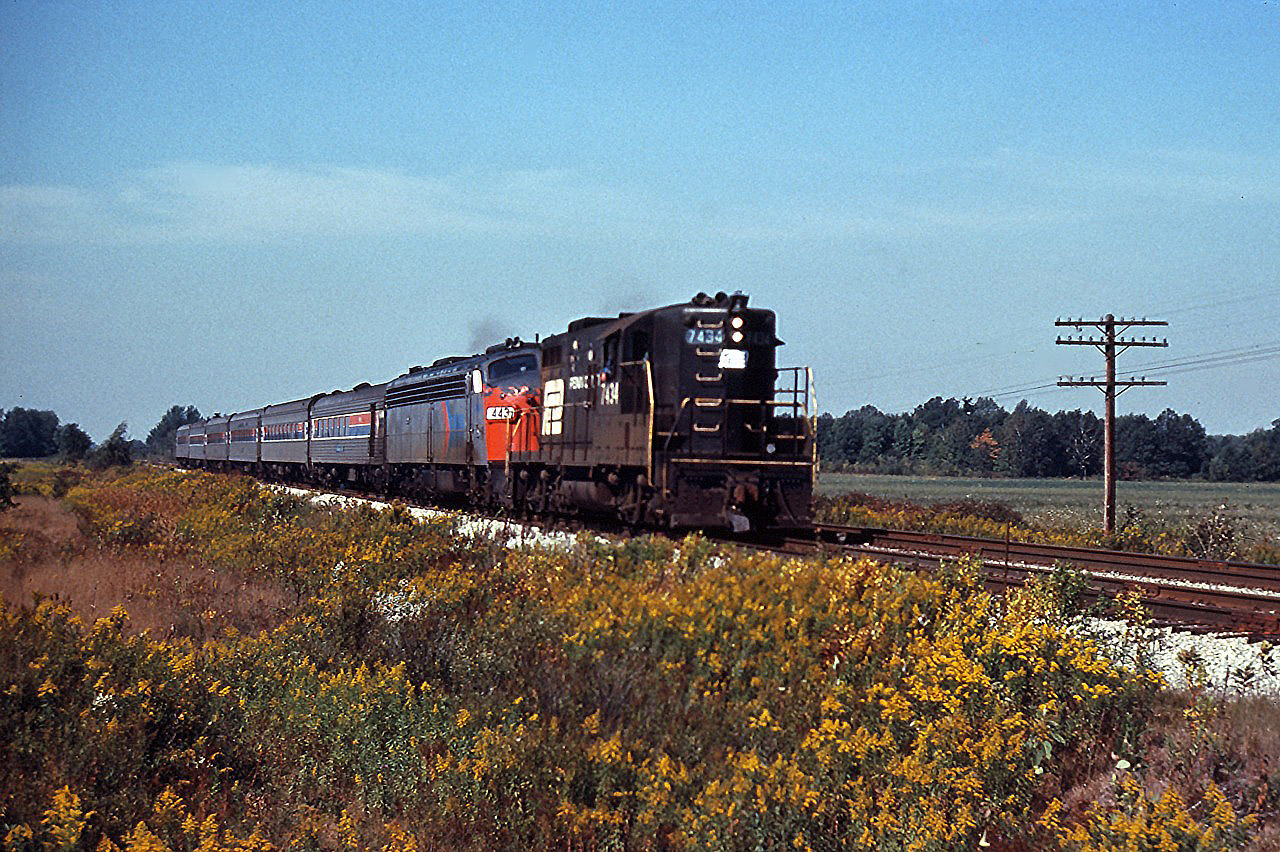 Penn Central GP9 7434 assists Amtrak E-unit 443 move the "Niagara Rainbow" (Detroit-Buffalo via the Canada Southern) through Canfield. This was probably necessitated by a power failure on the passenger train.