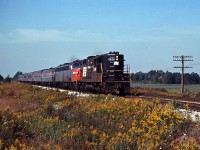 Penn Central GP9 7434 assists Amtrak E-unit 443 move the "Niagara Rainbow" (Detroit-Buffalo via the Canada Southern) through Canfield. This was probably necessitated by a power failure on the passenger train.