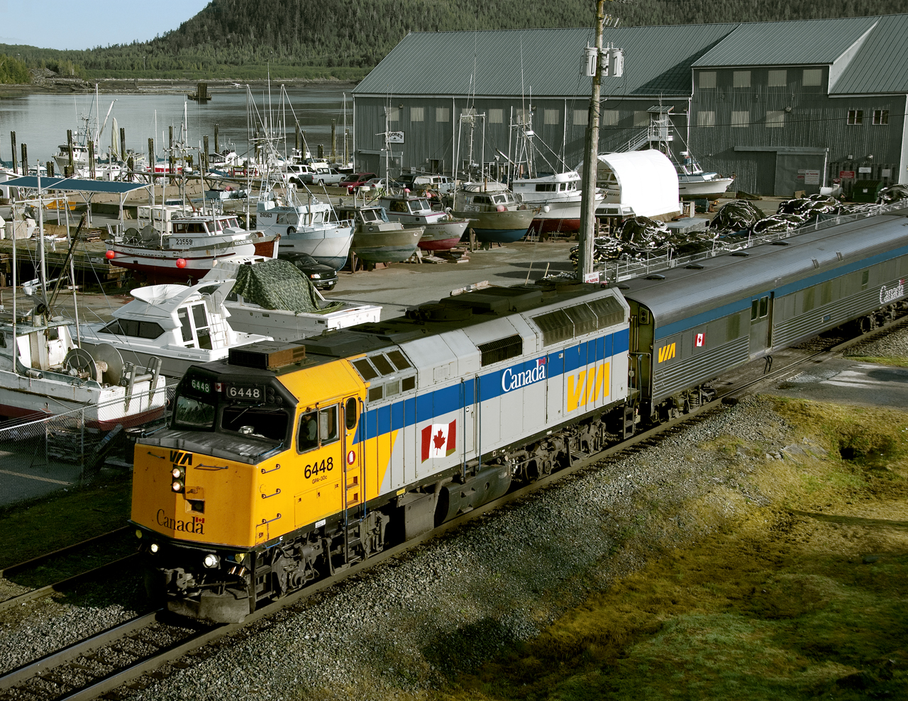 Eastbound Via's "Rupert Rocket" passes dry-docked fishing boats along the salmon rich Skeena River estuary