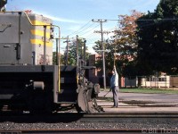 The operator at Woodstock has his train order hoop held at the ready for the head-end crew of a westbound CP freight (lead by former QNS&L SD40 204) to grab on the fly, as they cross Ingersoll Ave. on the Galt Sub. A second train order hoop in the other hand is all set for the tail-end crew to pick up when the van passes by.