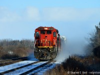 Dashing through the snow with a broom hanging by the nose, one of the few standard cab GE's on the CN roster -  CN 2126 is on the home stretch to Sarnia, Ontario.