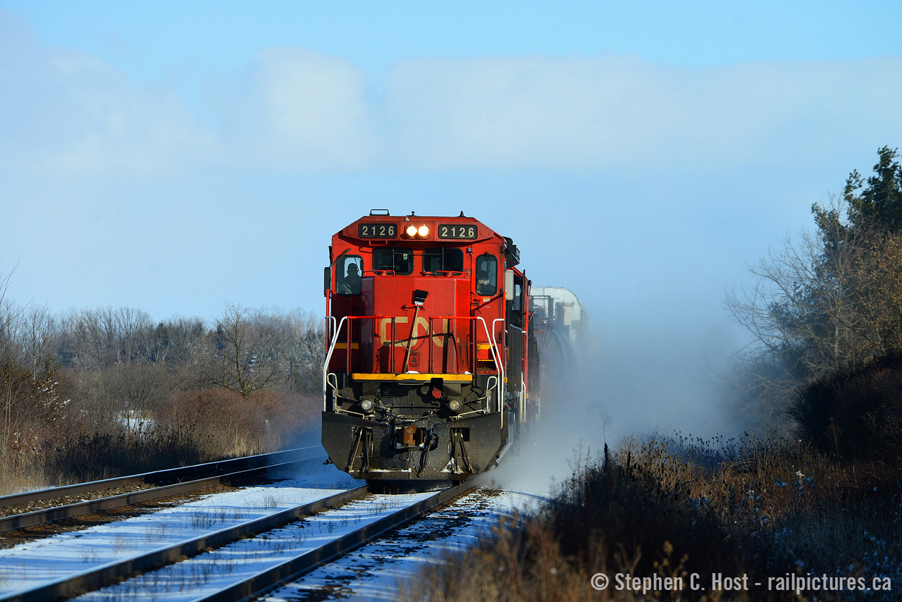 Dashing through the snow with a broom hanging by the nose, one of the few standard cab GE's on the CN roster -  CN 2126 is on the home stretch to Sarnia, Ontario.