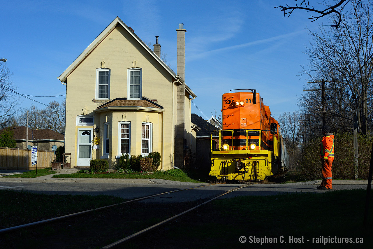 It's hard sometimes to think of the scale of what we photograph, but trains are actually quite large. This photo should put it into perspective, as 'house sized' QGRY 2301 passes a dwelling at the corners of Rose and Port St in Brantford, at 0800 back in 2015.
One can't mistake the correlation between the safety vest of SOR 598's conductor and the paint on QGRY 2301. A friend called G&W the "Safety Vest Railway" and I agree.