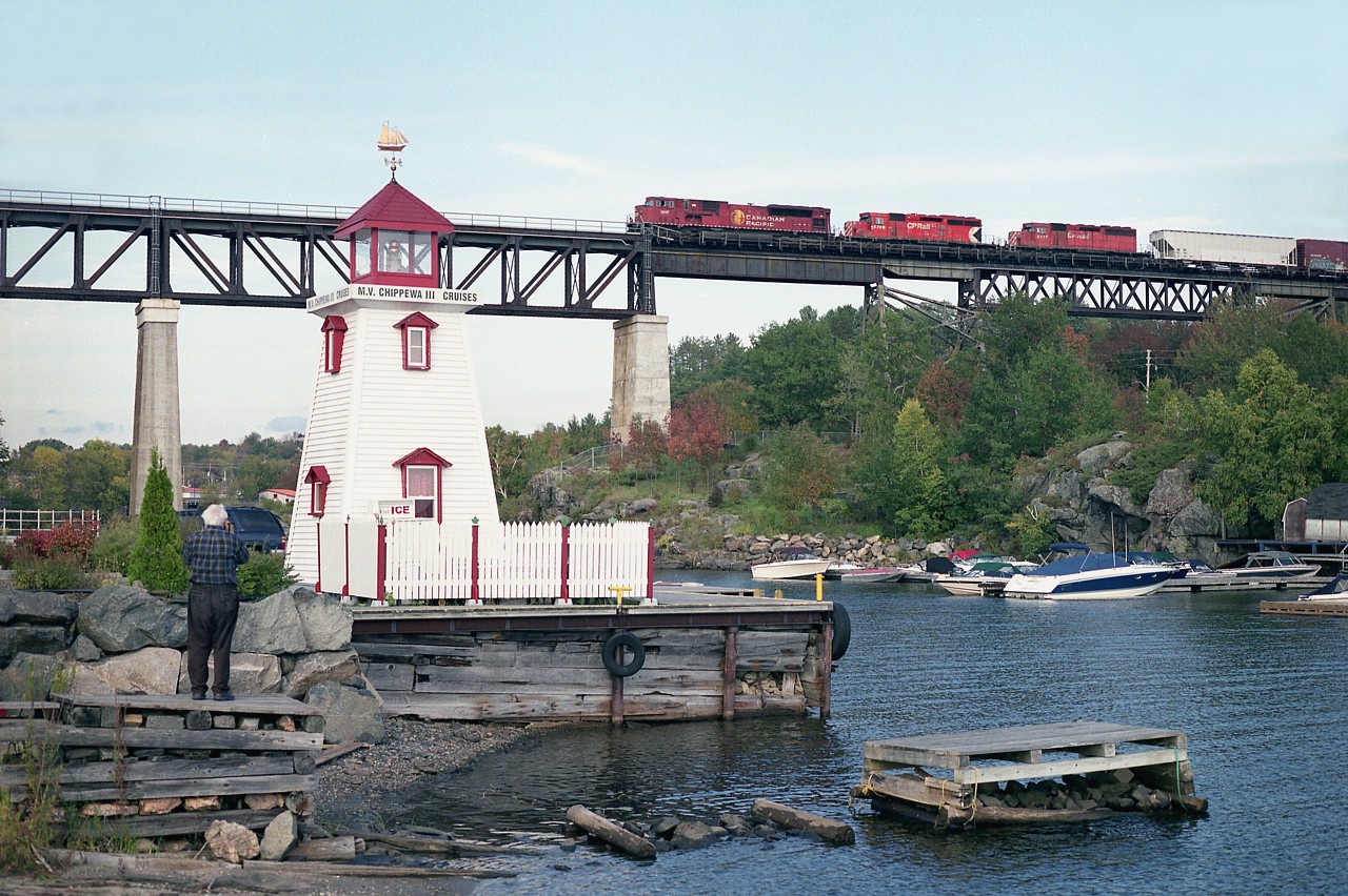 I was rather worried about whether I would catch an SD90MAC in the lead after hanging around Parry Sound all day and not seeing one. But persistence paid off. Captured rolling northbound over the Parry Sound trestle is CP 9117,along with SD40-2s 5745 and 5717.
 The railfan on the ready to the left of the "lighthouse" is Don McQueen, who was on another safari at the time with George Schaller & Bill Thomson. I'm sure all were pleased with their shots of this train.
 CP 9117 along with the rest of the surviving MACs was in storage, according to the most recent Trackside Guide.