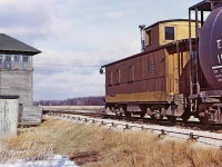 A Bruce Mercer image shows TH&B 63 caboose on the rear of the train, just
clearing the diamond at E&O Tower, southbound to Port Maitland.
 During my one plus year with the TH&B I did 12
trips on the East Local. We went on duty at Aberdeen yard mid-morning
around 9am. Usually it was a four person crew, Engineer, Conductor and
two Brakemen although sometimes we did have a Fireman, making a five man
crew. Trips varied in length from 8 hours to 12 hours or so. Departing
Aberdeen we would stop at Smithville and do some switching there and
then exit the Welland sub for the Dunnville sub and the 19 mile jaunt to
Port Maitland. Arriving at Port Maitland we would have a quick lunch
break and then start the heavy switching at the ERCO fertilizer plants.
We would eventually finish our work and building our train and then head
back to Smithville and eventually Aberdeen yard in Hamilton. Sometimes
we would take another break in Dunnville at the local greasy spoon
restaurant.