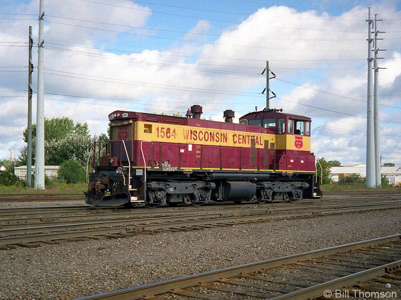 During a visit to the Algoma Central Railway to ride some of its passenger trains, a visit to Steelton Yard in Sault Ste. Marie finds Winsconsin Central SW1500 1564 sitting alone in the yard. ACR was owned by Wisconsin Central at the time, and seeing WC power was a common occurrence (this was two years before the CN takeover). 

This unit was originally built by EMD in 1971 for the Kentucky & Indiana Terminal Railroad (K&IT), and went on to work for Southern, Norfolk Southern, Wisconsin Central and finally CN where 1564 remains active today painted in the current CN livery.