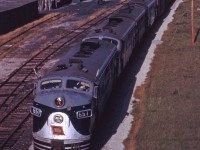 Although the Wabash has recently been acquired by the Norfolk & Western (October 1964), there are no signs of the change in ownership as an extra west rolls though Cayuga behind four F7As on a fine late fall/early winter day in 1964.