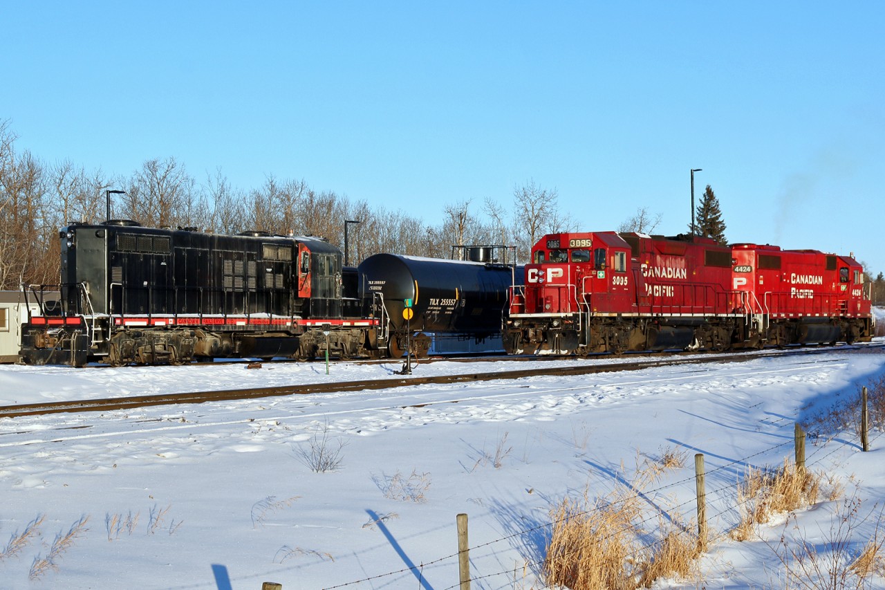 A pair of CP GP38-2s and an unidentified Canadian Railserve GP9 sit in CP's Scotford Yard.