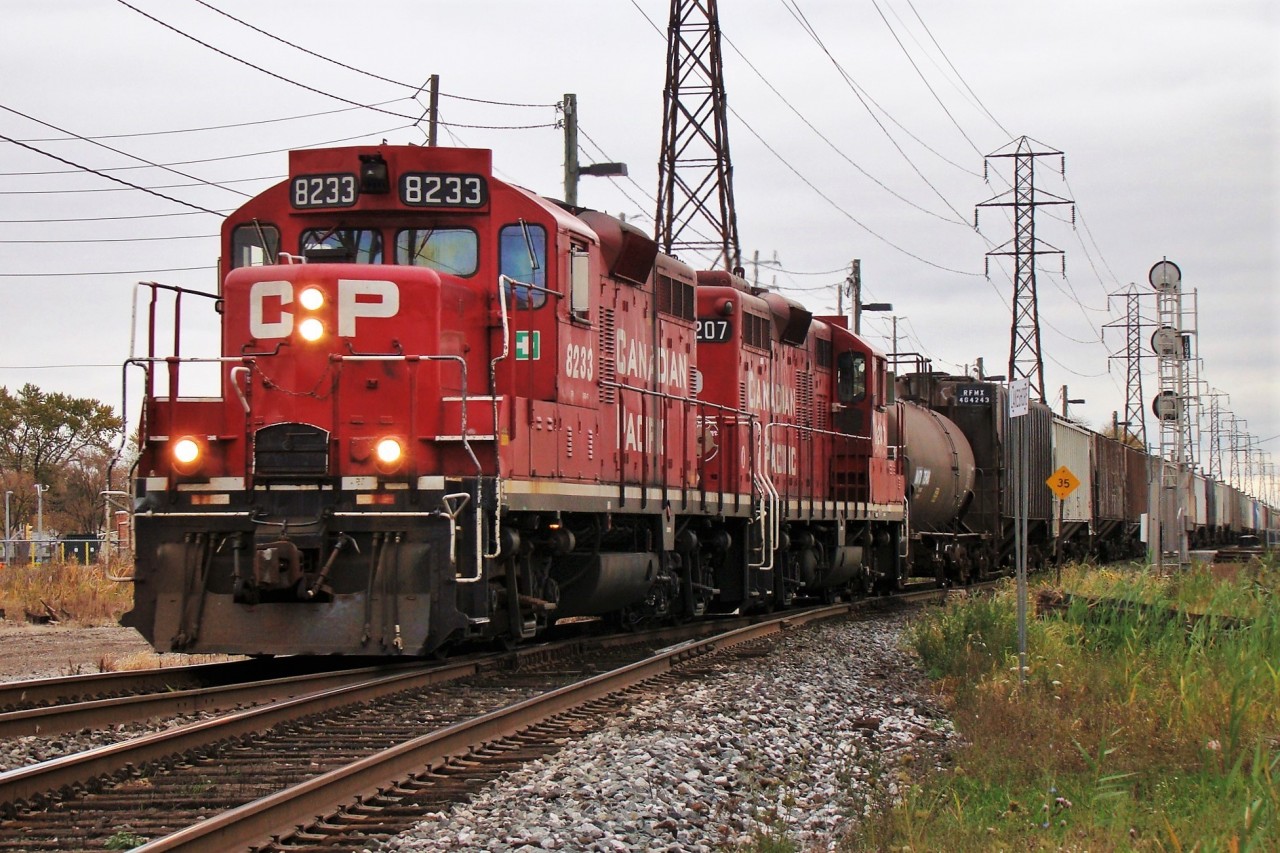 CP 8233 and 8207 lead a long local back to Windsor yard passing Lakeshore Jct. after working customers between here and Glencoe.