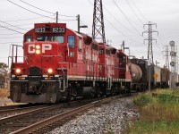 CP 8233 and 8207 lead a long local back to Windsor yard passing Lakeshore Jct. after working customers between here and Glencoe.