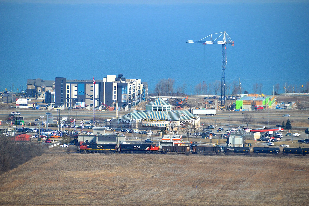 As far as the train goes, nothing to see here folks:o)  But thanks to Dean Brown I knew this train was coming and thought it was about time I set up for a "BEFORE" photo as this is where the new Grimsby GO Station and parking area will be located. In the photo one can see construction of more dwellings along the lake, the QEW and the 'Gateway'; a noted stop off Casablanca Blvd for locals and highway travelers alike.  I suspect this area will undergo major change in the coming years. Trouble is, at the speed most anything government gets done, I only hope I am still above ground by the time the complex opens !!  Second unit is CN 5787 and the time was 1135.  Rare digital effort from me, on a sunny but hazy morning.