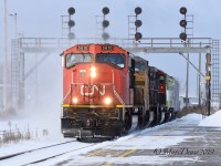 A sunny but frosty morning in Sarnia, ON., as train 394 rolls by Hobson with CN 5610 leading followed by GECX 9450, CN 5725 and GO 676.