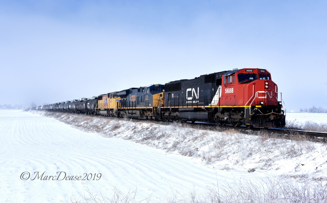 A colourful trio of power and no leasers on 394 as they blow past Wyoming, ON., on a blustery winter day with CN 5688, CSX 3321 and UP 4188.