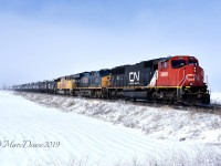 A colourful trio of power and no leasers on 394 as they blow past Wyoming, ON., on a blustery winter day with CN 5688, CSX 3321 and UP 4188.