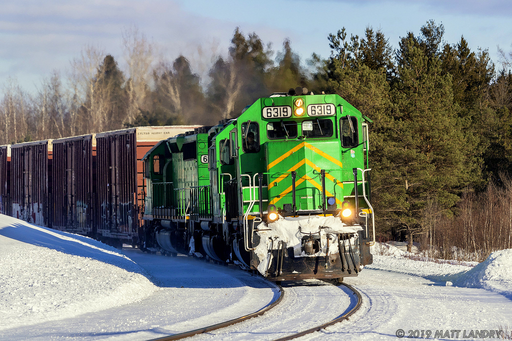 With some nice late day sun reflecting on the snow, NBSR 6319 rounds the bend, at Tracy, New Brunswick.
