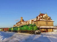 Near Sunset, NBSR train 907 passes by the famous railway station at McAdam, New Brunswick. 