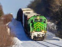 Shot at 600mm with my Sigma 150-600mm lens, a trio of green leads NBSR train 907, as they head down grade approaching Cork, New Brunswick. The telephoto shot makes the grade look steeper than it actually is. 