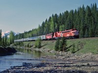 Under beautiful mountain skies, VIA 2, the Canadian is 14 miles from the division point of Field BC.  The colourful consist shows the varied heritage of much of the equipment. 