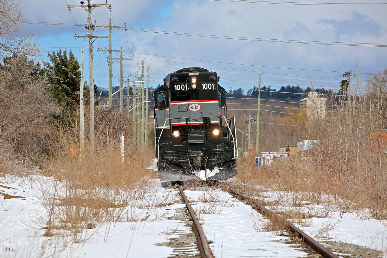 CCGX 1001 leans to one side as it slowly shoves empty dimensional car WDLX 1001 along the overgrown Western Mechanical Spur north of Tiffin St in Barrie.  This is a rare move as Western Mechanical only requires service a handful of times per year.  Earlier that morning I had driven over this spur while running errands in town and noticed a crew armed with pickaxes clearing ice from the rails at Brock St.  I guessed that something was up so I abandoned my errands (my wife calls this being irresponsible) and chased down the BCRY train in Innisfil where I found their train consisting of WDLX 1001 along with an empty centrebeam for Tarpin Lumber and a tank car for Comet Chemicals.  With my suspicions confirmed I played the waiting game until they had finished their work in Innisfil and was able to get this shot when they made their return trip through Barrie.