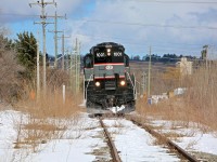 CCGX 1001 leans to one side as it slowly shoves empty dimensional car WDLX 1001 along the overgrown Western Mechanical Spur north of Tiffin St in Barrie.  This is a rare move as Western Mechanical only requires service a handful of times per year.  Earlier that morning I had driven over this spur while running errands in town and noticed a crew armed with pickaxes clearing ice from the rails at Brock St.  I guessed that something was up so I abandoned my errands (my wife calls this being irresponsible) and chased down the BCRY train in Innisfil where I found their train consisting of WDLX 1001 along with an empty centrebeam for Tarpin Lumber and a tank car for Comet Chemicals.  With my suspicions confirmed I played the waiting game until they had finished their work in Innisfil and was able to get this shot when they made their return trip through Barrie.