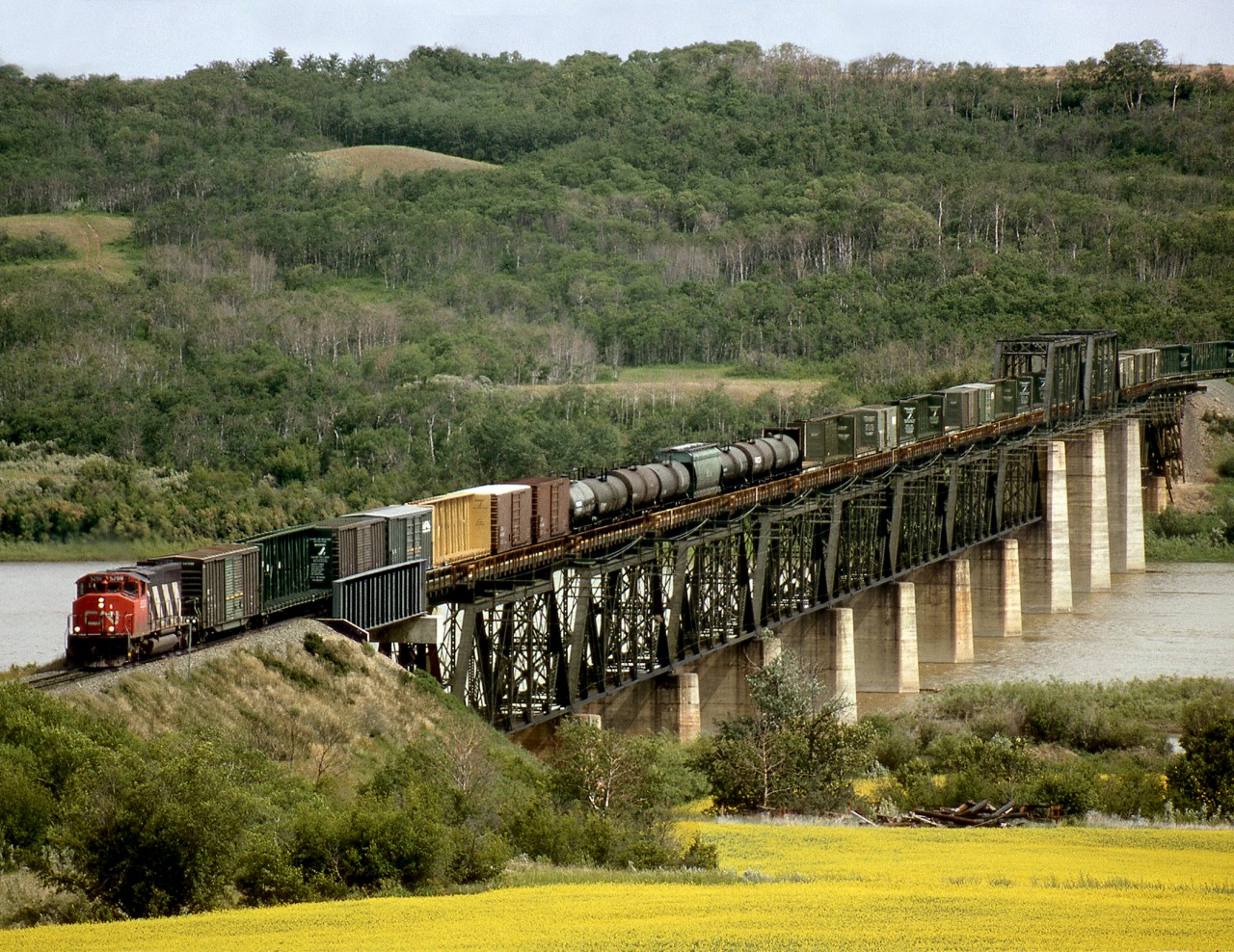 Westbound general freight 359 operating on the Prairie North Line crosses the North Saskatchewan River west of North Battleford. This was the junction for a spur to Battleford town located in the valley below the city of North Battleford