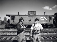 "This is one of the last vans on the system with an operating toilet".  The conductor and brakeman pause in Merrictton Yard the last day CN train 549 serviced St. Catherines and Thorold.  The Port Colborne Harbour Railway started up the next day.