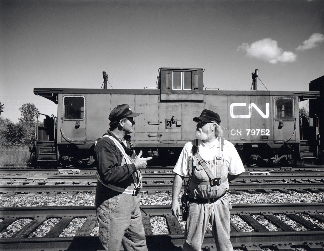 "This is one of the last vans on the system with an operating toilet".  The conductor and brakeman pause in Merrictton Yard the last day CN train 549 serviced St. Catherines and Thorold.  The Port Colborne Harbour Railway started up the next day.
