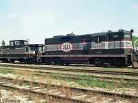 Cando Contracting's GP9 CCGX 1000 sits with caboose 200001 at Orangeville Yard in 2001. Unit 1000 was the initial power for the Orangeville-Brampton Railway when Cando started operationing the line for the Town of Orangeville in the early 2000's, but was eventually replaced with 4009 (an ex-CN rebuilt GP9). Caboose 200001 (ex-CN 79843) was eventually sent west to operate on Cando's Central Manitoba Railway (CEMR).<br><br>As of present-day, Cando has been replaced by Trillium as operator of the OBRY.