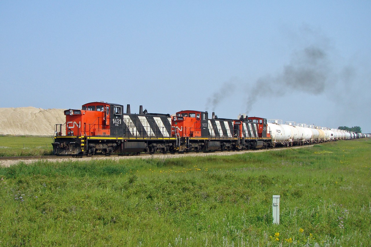 Definitely a blast from the past, GMD1s switching at CN's Scotford Yard.  Have not been seen for many years now.  Here CN 1421, 1433 and 1409 bring tank cars off the lead into the yard.
