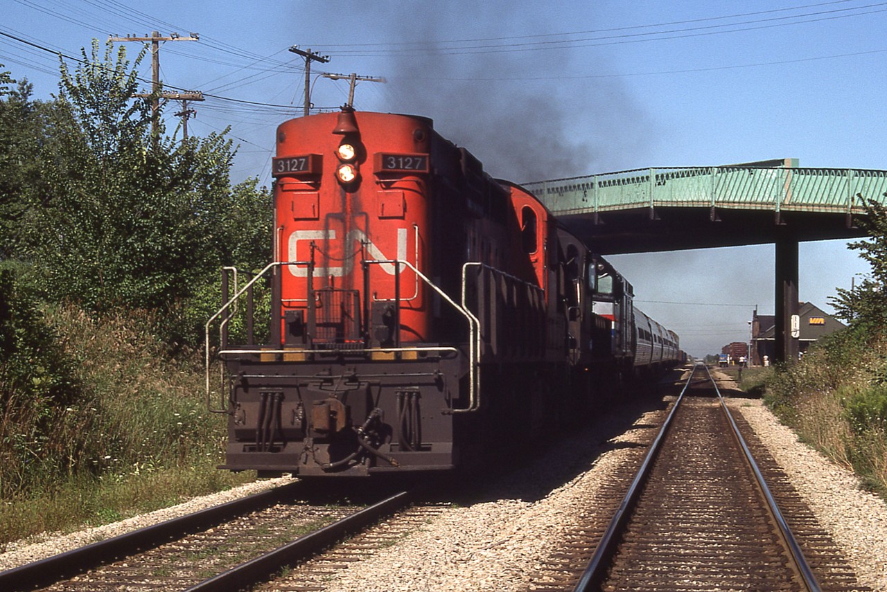 It looks like MLW to the rescue!!  I was just moseying around one day and happened to be near the station and near 'train time' so thought I would check. Much to my surprise, it wasn't the same old, same old, but rather #97 with AMTK 343 was disabled for whatever reason and a couple of old RS-18s had come to the rescue. I had to make a mad dash to even get a so-so shot such as this.......CN 3127 and 3121 taking the train to the border. That is the St. Kitts station on the right background, the train is going under the St. Paul W bridge.