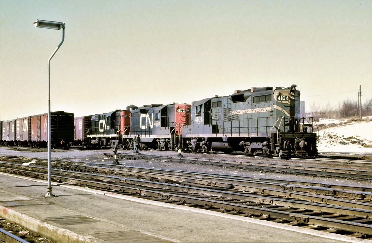 CN train 474 begins its journey south from Capreol on a pleasant March 1969 afternoon (perhaps 50 years ago today).  Power for the train consists of GP9s 4104 and 4570 and RS-18 3113.  Note the conductor standing beside the train waiting for it to pass so that he may board the caboose.  Railroading as it was meant to be!