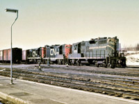 CN train 474 begins its journey south from Capreol on a pleasant March 1969 afternoon (perhaps 50 years ago today).  Power for the train consists of GP9s 4104 and 4570 and RS-18 3113.  Note the conductor standing beside the train waiting for it to pass so that he may board the caboose.  Railroading as it was meant to be!